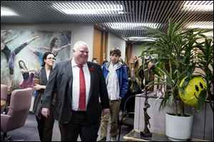 Toronto Mayor Rob Ford leads a tour of city hall staff member's children around the offices at city hall on take you kids to work day Wednesday in Toronty. 