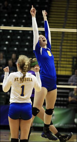 St. Ursula's Lauran Graves, 8, leaps for joy after hitting the match winner during a Div. I state semi-final volleyball game today at the Nutter Center in Fairborn, Ohio.