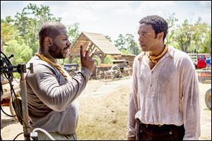 Director Steve McQueen, left, discusses a scene with lead actor Chiwetel Ejiofor on the set of  '12 Years a Slave.'