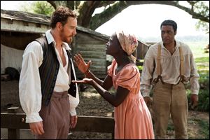 This image released by Fox Searchlight shows Michael Fassbender, left, Lupita Nyong'o and Chiwetel Ejiofor, right, in a scene from 