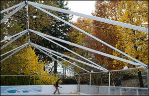 Chris Martin, park operations manager at the Toledo Zoo, blows off leaves from the  ice rink that will be available during the zoo’s annual Lights Before Christmas display, which opens Friday.
