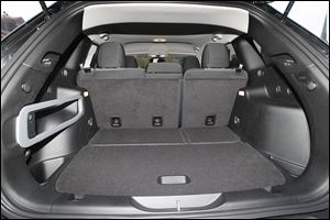 The back seats split 60-40 and fold down flat. The Cherokee doesn't have as much cargo space as the Honda CR-V and Toyota RAV4. The back seat sits three, but not very far if comfort is desired.