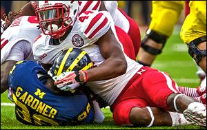 Nebraska defensive end Randy Gregory sacks Michigan’s Devin Gardner in the first quarter. The Wolverines had minus-21 yards rushing Saturday and are minus-69 rushing the past two games.