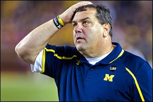 UM coach Brady Hoke glances at the scoreboard. He lost for the first time at Michigan Stadium.