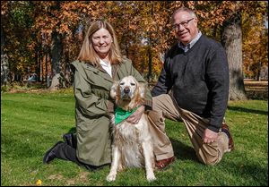 Sandy Drabik and D. Michael Collins pose with their dog Chloe at their South Toledo home. Ms. Drabik plans to support and counsel the mayor-elect as well as concentrate on  his push for a concept called ‘Tidy Towns.’