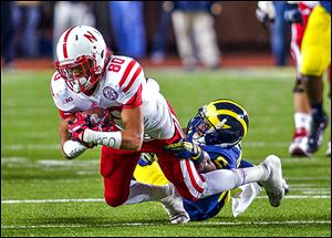 Nebraska wide receiver Kenny Bell makes a reception against Michigan defensive back Raymon Taylor in the fourth quarter.