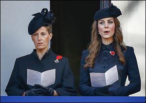 Britain’s Catherine, the Duchess of Cambridge, right, and Sophie, the Countess of Wessex, sing from a balcony during the service of remembrance.