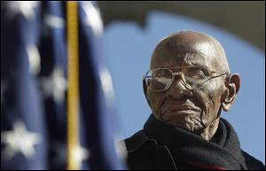 World War II veteran 107 year-old Richard Overton, center, from East Austin, Texas, stands up for the presentation of the colors during Veteran Day ceremony at Arlington National Cemetery Amphitheater.