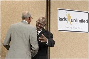 Toledo Mayor Mike Bell greets Detroit Mayor Dave Bing during the Kids Unlimited State of the Child banquet Monday at the Pinnacle in Maumee.