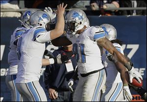 Detroit receiver Calvin Johnson, right, celebrates his touchdown reception with quarterback Matthew Stafford during the second half against the Bears. The Lions won to improve to 6-3.