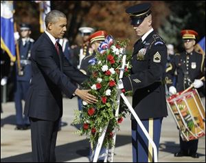 President Obama places a wreath at the Tomb of the Unknowns at Arlington National Cemetery in Arlington, Va., today.