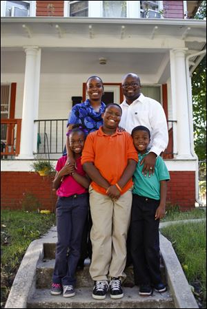 The Rev. Randall Parker III, his wife, Louise,and their children Kennedi, 8, left, Caleb, 10, and Cameron, 8,are fixtures in the Old West End. 
