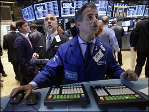 Trader John Liotti, left, and specialist Anthony Rinaldi work on the floor of the New York Stock Exchange today.