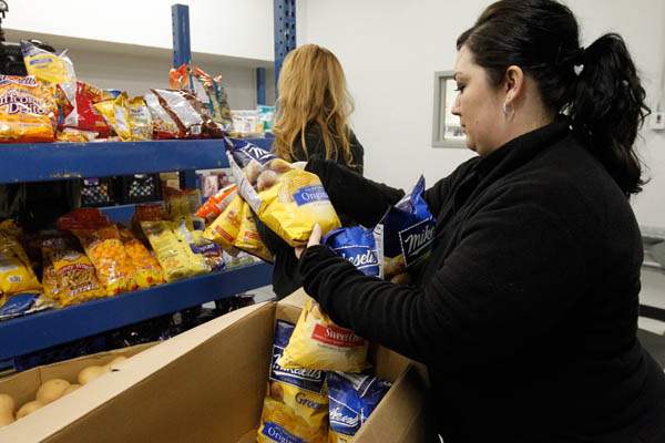 Kim-Lilienthal-unloads-and-shelves-food-at-th