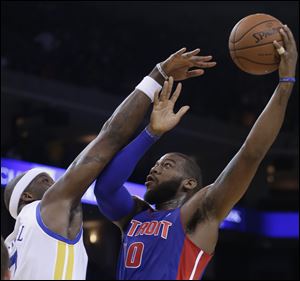 Detroit Pistons' Greg Monroe, right, shoots over Golden State Warriors' Jermaine O'Neal.