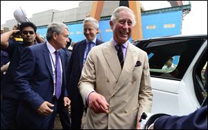 Britain's Prince Charles smiles as he interacts with officials during a visit to a shipyard to see India’s first Indigenous Aircraft Carrier INS Vikrant in Kochi, India, Tuesday. Charles and his wife Camilla, the Duchess of Cornwall, are on a nine-day visit to India. 