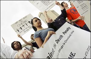 In this 2007 file photo, people rally at the Ohio Statehouse to oppose the death penalty.