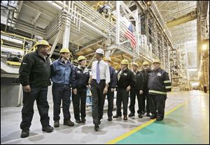 President Obama talks with workers at ArcelorMittal Cleveland, a steel mill he visited to discuss the economy and manufacturing. From there he headed to Philadelphia for Democratic fund-raisers.