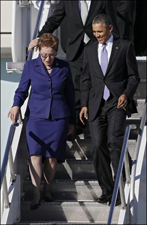 President Barack Obama, accompanied by Rep. Marcy Kaptur, D-Ohio, exit Air Force One today at Cleveland Hopkins International Airport.
