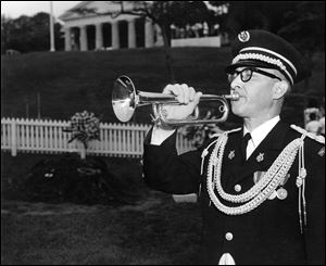 Army bugler Keith Clark, who played taps during John F. Kennedy's funeral, plays the bugle at Mr. Kennedy's grave in 1964, a year after the president's assassination. 