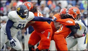 Toledo nose tackle Treyvon Hester grabs Bowling Green's Travis Greene. Hester, a freshman, has registered six tackles for losses and 3½ sacks for the Rockets this season.