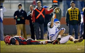 Detroit Catholic Central's Nicholas Cococcetta scores the game-winning touchdown against Bedford's Lucas Mayo with 25 seconds left in the game. The Mules finish the season 11-1.