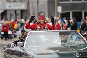 Grand marshal and Spec. Stephanie Morris of the Army, who was wounded in Afghanistan, receives a standing ovation as she heads down the parade route. Specialist Morris is a 2007 graduate of Libbey High School.