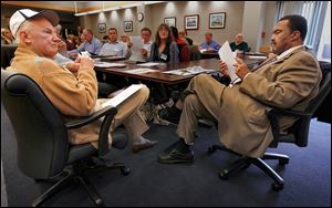 Former Toledo Mayors Carty Finkbeiner, left, and Jack Ford, right, are among about 45 people at a D. Michael Collins' transition team meeting at the Maritime Academy of Toledo.