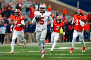 Ohio State quarterback Braxton Miller (5) runs for a 70 yard touchdown as Illinois defensive back Zane Petty (21) defensive back V'Angelo Bentley (2) and defensive back Earnest Thomas III (9) chase him during the first half.