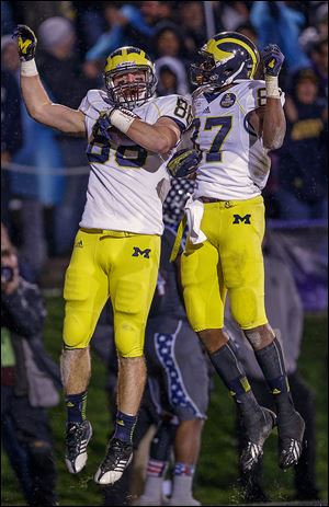 Michigan tight end Jake Butt, left, celebrates with Devin Funchess after scoring a touchdown during the first overtime.
