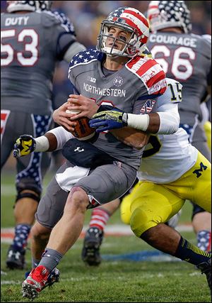 Michigan linebacker James Ross III sacks Northwestern quarterback Trevor Siemian in Saturday's game.