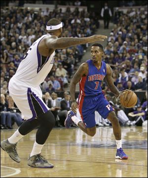 Detroit Pistons guard Brandon Jennings, right, looks to drive against Sacramento Kings  center DeMarcus Cousins during the first quarter of an NBA basketball game in Sacramento, Calif., Friday, Nov. 15, 2013. (AP Photo/Rich Pedroncelli)