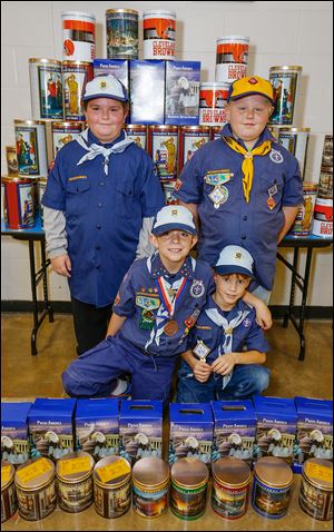 Ryan Marks, 9, front left, and Jack Callan, 8, right, pose with Gavin Leahy, 8, back left, and Daniel Lilly, Jr., 7,  with almost $2,000 in popcorn that will be going to Ohio military troops far from home.