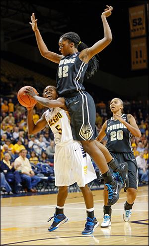 Toledo’s Janelle Reed-Lewis is fouled by Purdue’s Camille Redmon while taking a shot.