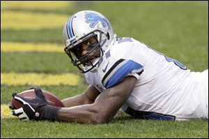 Detroit Lions wide receiver Calvin Johnson lays in the end zone after scoring one of his two touchdowns Sunday in Pittsburgh.