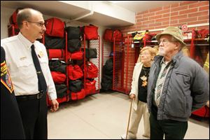 Deputy Chief Mike Froelich, left, explains the climate-controlled gear room to former Sylvania Township trustee Bruce Wharram and his wife, Mary, during Sunday’s open house. 