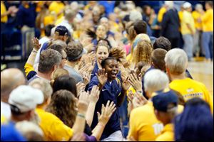 University of Toledo player Janelle Reed-Lewis leads the Rockets out through a tunnel of fans to play No. 18 Purdue University.