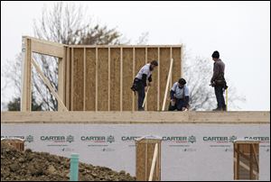 Workers build a new home in Pepper Pike, Ohio.