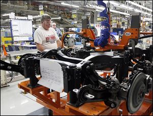 An employee works on the the new Jeep Cherokee line at the Toledo Assembly Complex.