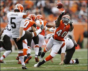 Cincinnati strong safety Shawn Williams deflects a second-quarter punt by Cleveland's Spencer Lanning. The punt went nine yards and led to a Bengals touchdown.