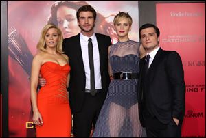 Elizabeth Banks, Liam Hemsworth, Jennifer Lawrence and Josh Hutcherson attend the LA premiere of 'The Hunger Games: Catching Fire' Monday in Los Angeles.