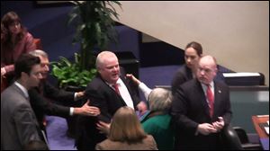 Toronto Mayor Rob Ford is shown in a video frame grab as he knocks down Councillor Pam McConnell as he ran toward hecklers in the audience at City Hall Monday.