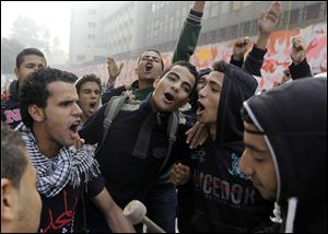 Egyptians chant anti-police slogans at the entrance of Mohammed Mahmoud street near Tahrir Square, Cairo, Egypt, Tuesday.