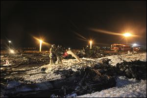 Firefighters and rescuers work at the crash site of a Russian passenger airliner near Kazan, the capital of the Tatarstan republic, about 450 miles east of Moscow, Sunday.