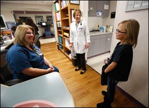 Allison Herr, 10, of Metamora, talks with nurse Jean Jeskey, left, in the Pediatric ICU at Mercy St. Vincent Medical Center.