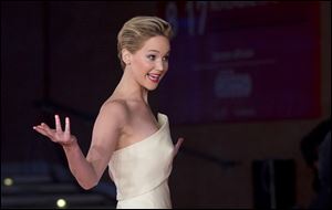 Actress Jennifer Lawrence gestures to photographers as she arrives for the screening of the movie 'The Hunger Games: Catching Fire', at the 8th edition of the Rome International Film Festival, in Rome last Thursday.