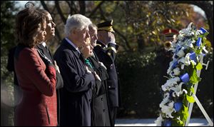 President Obama, first lady Michelle Obama, former President Bill Clinton and his wife, former Secretary of State Hillary Clinton, pause during a wreath laying ceremony in honor of President John F. Kennedy, today, at  President Kennedy's gravesite at Arlington National Cemetery in Arlington, Va.