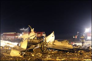 In this photo provided by Russian Emergency Situations Ministry, firefighters and rescuers work at the crash site of a Russian passenger airliner near Kazan, the capital of the Tatarstan republic, about 720 kilometers (450 miles) east of Moscow, on Sunday, Nov. 17, 2013. The Russian passenger airliner crashed Sunday night while trying to land at the airport in the city of Kazan, killing all 50 people onboard, officials said. The Boeing 737 belonging to Tatarstan Airlines crashed an hour after taking off from Moscow. There were no immediate indications of the cause. (AP Photo/Russian Emergency Situations Ministry)