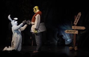 Donkey, played by Matthew Nolan, begs Shrek, played by Garrett Weddington, to keep him during dress rehearsal of 'Shrek the Musical' at Northview High School in Sylvania on Wednesday.