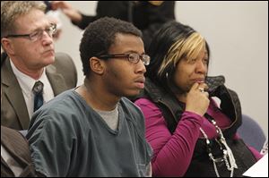 Kei’ron Toyer, 17, with his mother, Ebony Toyer, listens to the sentencing proceedings in Lucas County Juvenile Court. The Sylvania Southview student pleaded no contest to rape.